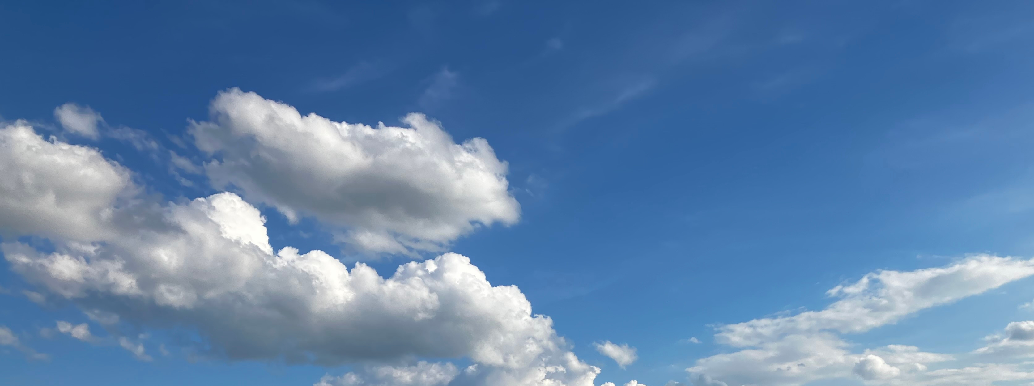 White clouds across a blue sky